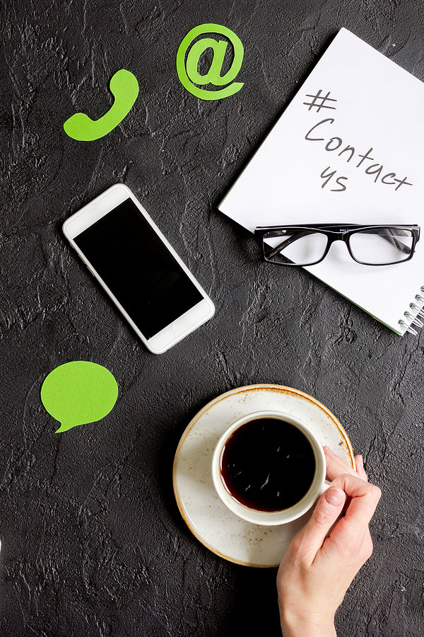Coffee, with notepad, glasses, phone, and contact symbols